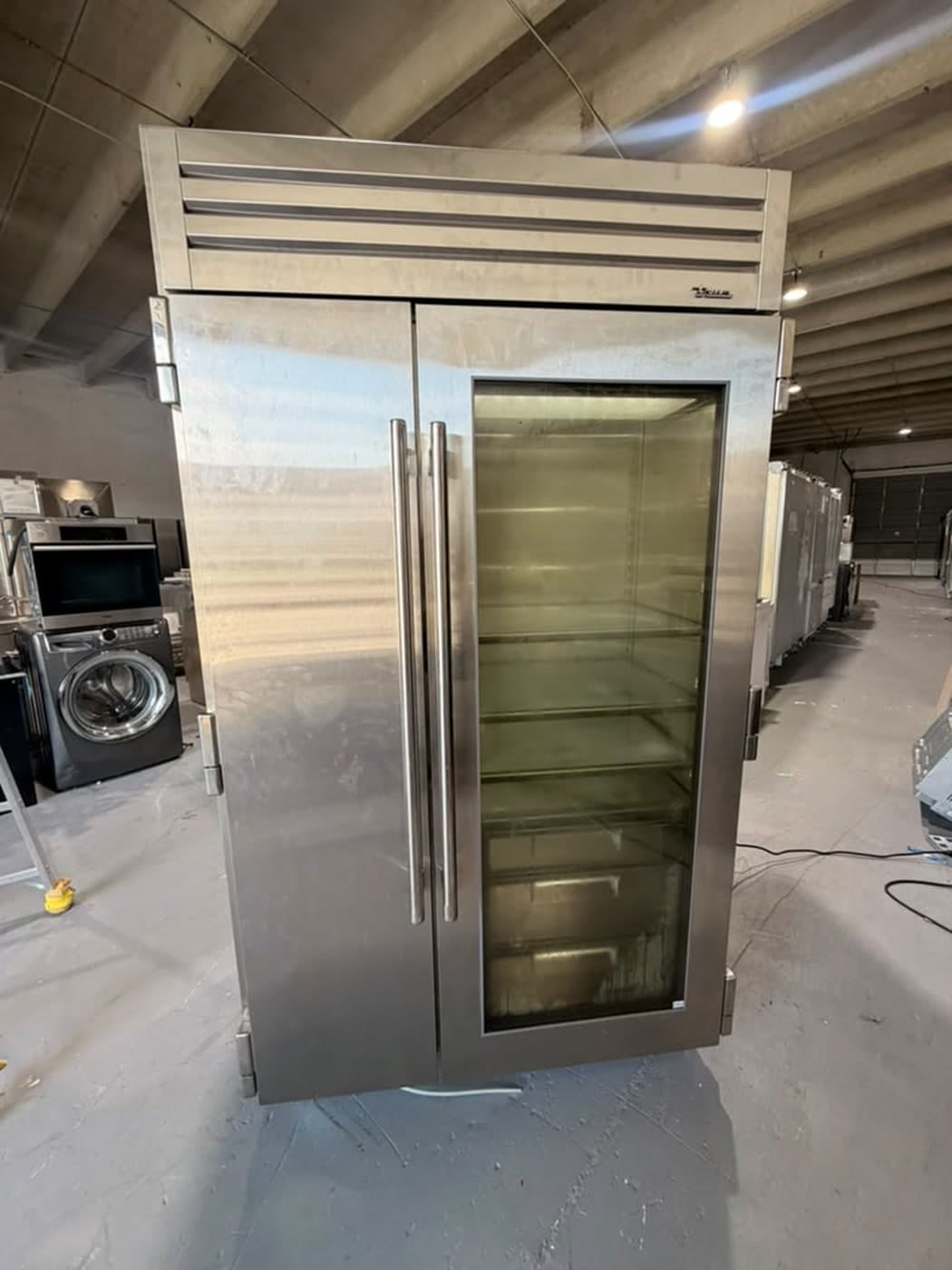 Actual true residential 48-inch refrigerator photographed in Oakland Park — actual true residential refrigerator, straight-on front view.