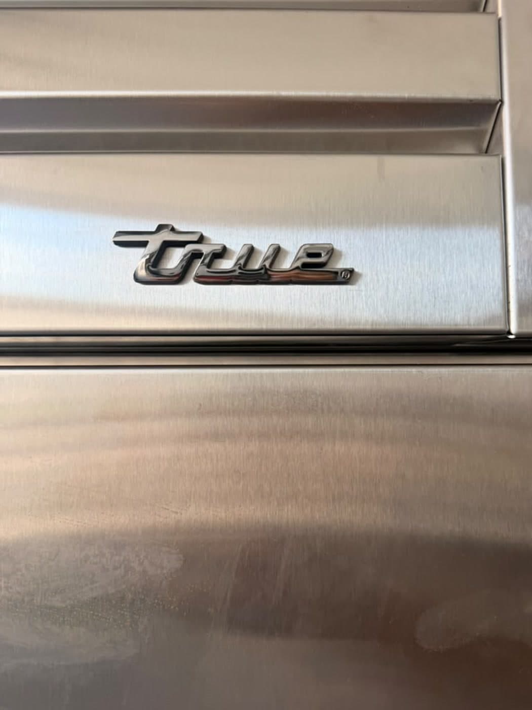 Actual true residential 48-inch refrigerator photographed in Oakland Park — actual-unit true residential branding detail.