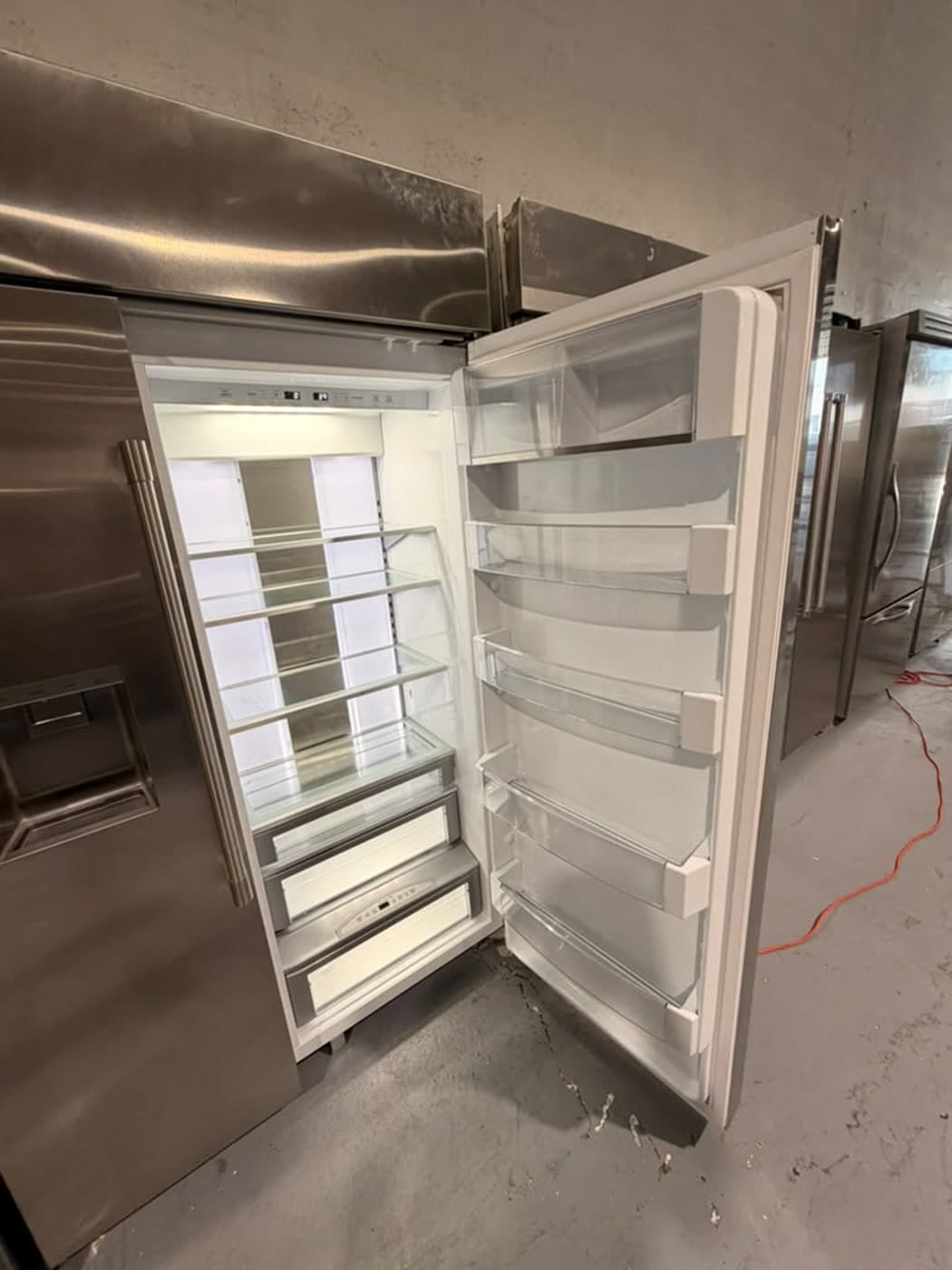 Actual monogram 48-inch side-by-side refrigerator photographed in Oakland Park — refrigerator interior and door storage