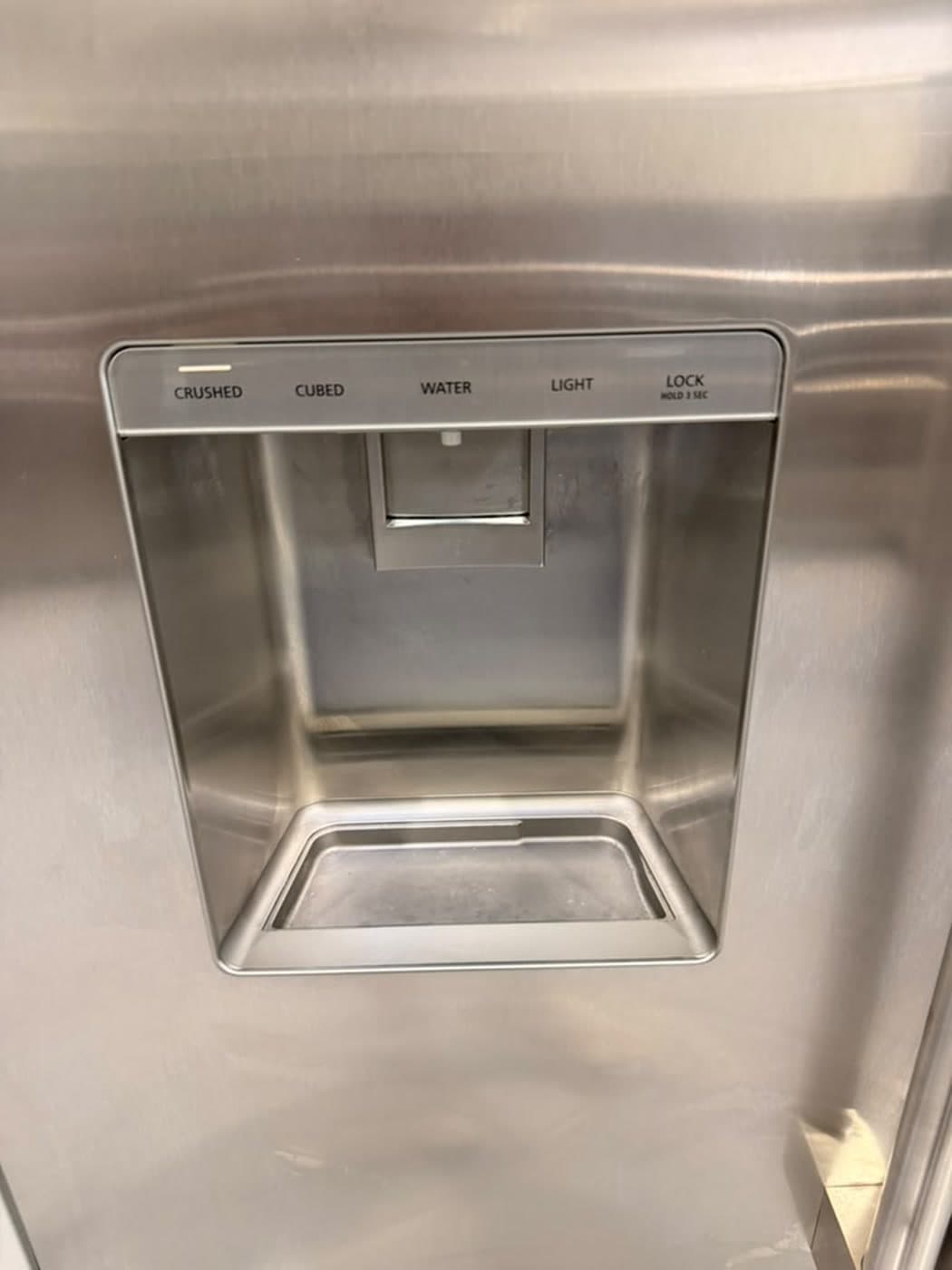 Actual monogram 48-inch side-by-side refrigerator photographed in Oakland Park — exterior water and ice dispenser detail