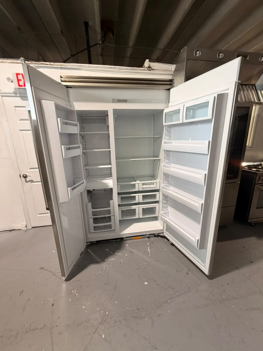 Actual viking 48-inch side-by-side refrigerator photographed in Oakland Park — open refrigerator and freezer interiors