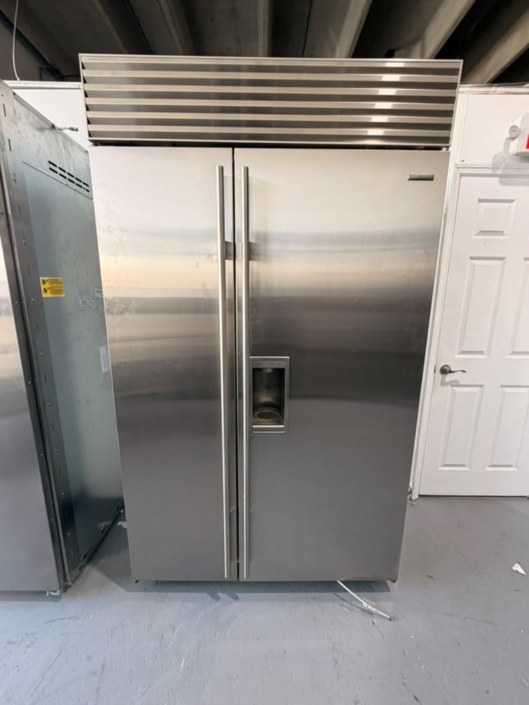 Actual sub-zero 48-inch side-by-side refrigerator photographed in Oakland Park — actual unit · closed front overview