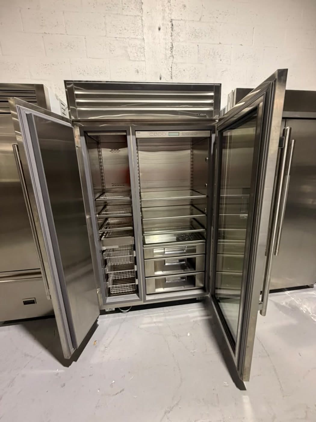 Actual true residential 48-inch glass-door refrigerator photographed in Oakland Park — actual unit · open front overview
