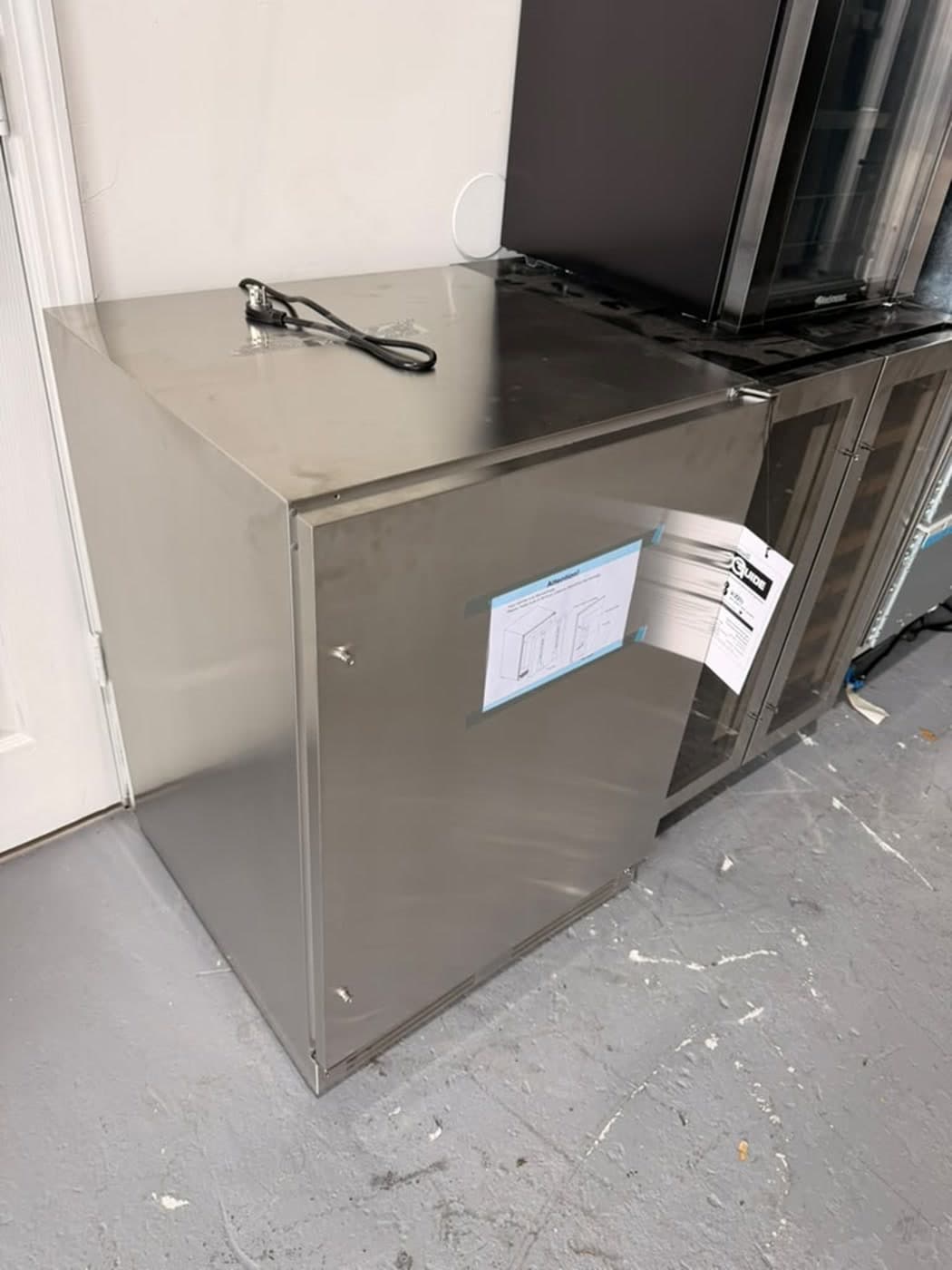 Actual xo 24-inch outdoor refrigerator photographed in Oakland Park — actual unit · closed side angle