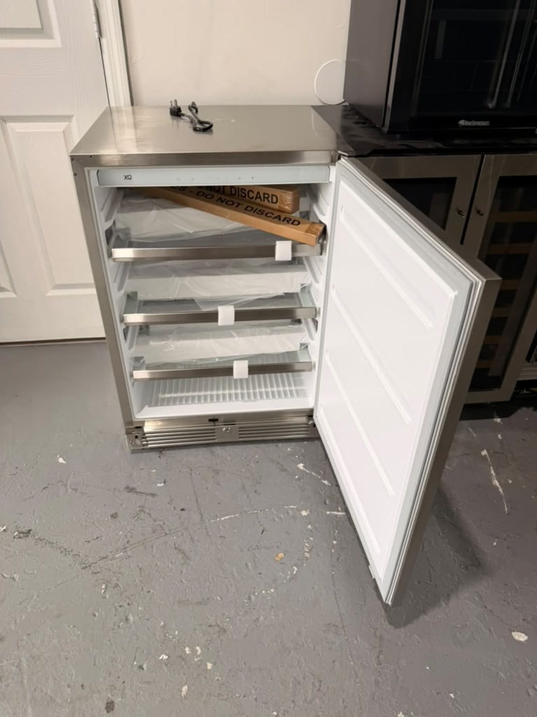 Actual xo 24-inch outdoor refrigerator photographed in Oakland Park — actual unit · open interior