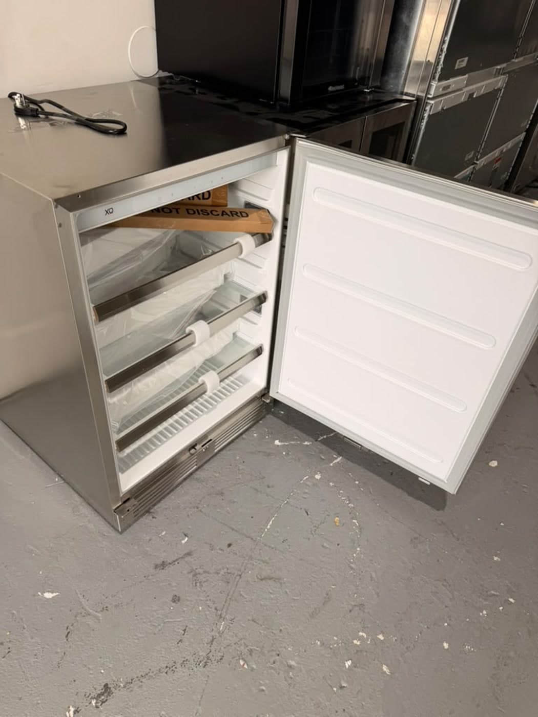 Actual xo 24-inch outdoor refrigerator photographed in Oakland Park — actual unit · open interior angle