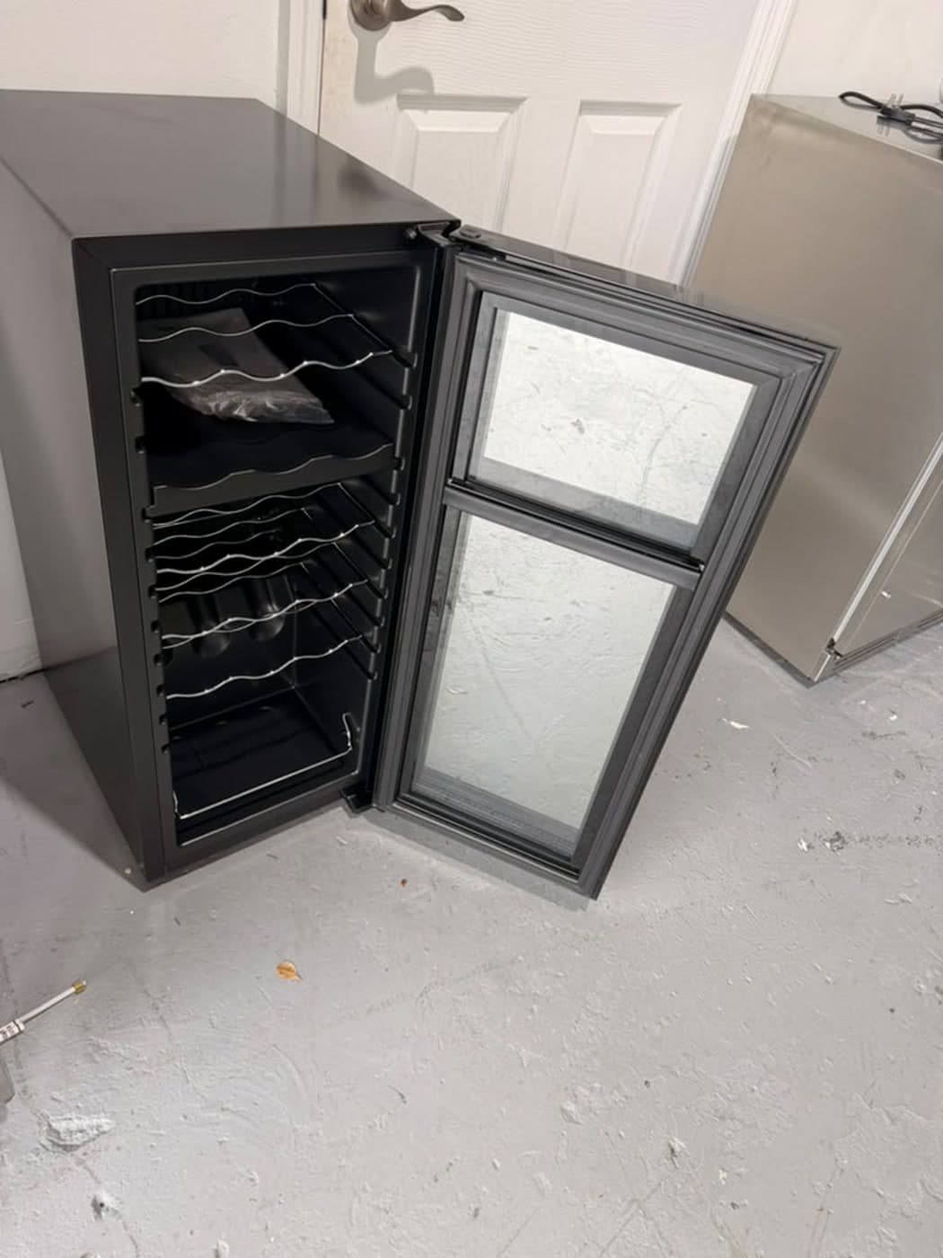 Actual wine enthusiast 18-bottle dual zone wine cooler photographed in Oakland Park — actual unit · open interior angle
