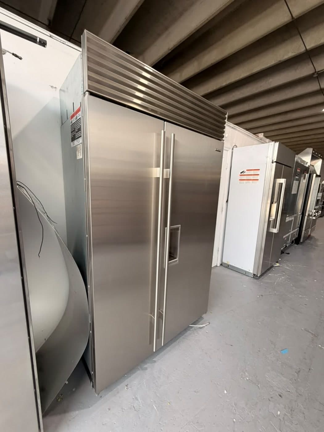 Actual sub-zero 48-inch side-by-side refrigerator with dispenser photographed in Oakland Park — actual unit · closed side angle