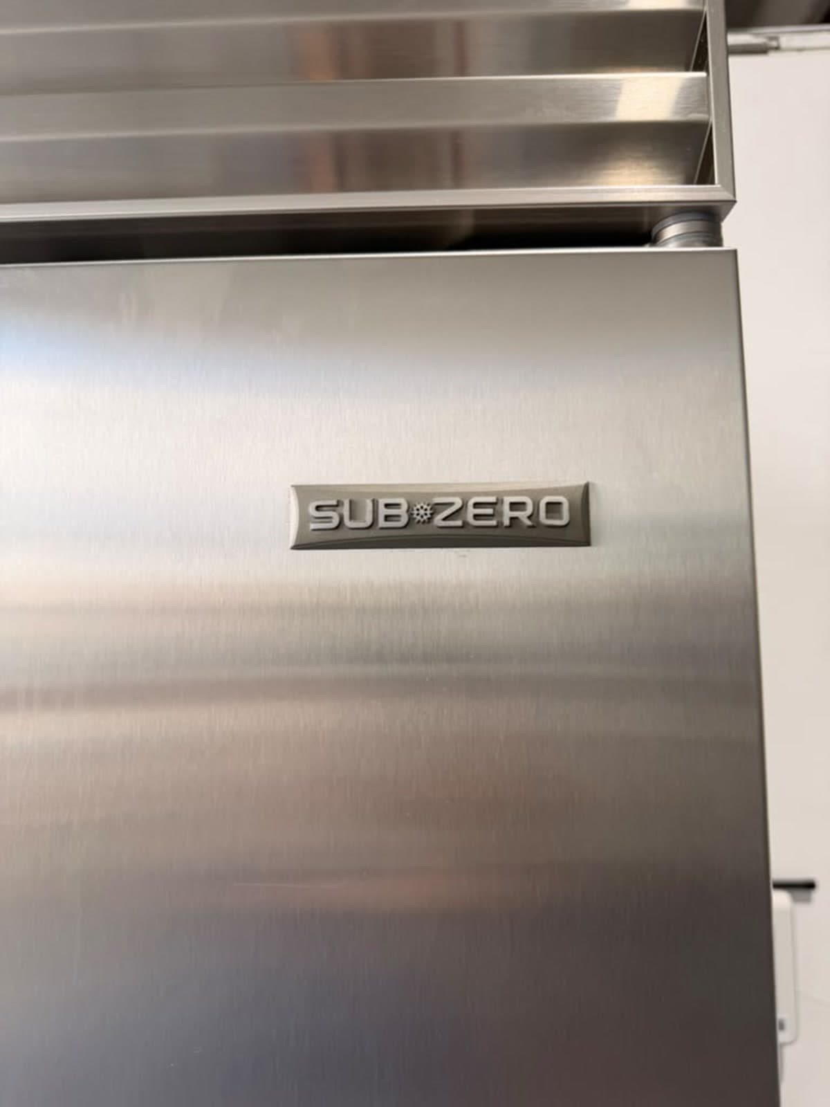 Actual sub-zero 48-inch side-by-side refrigerator with dispenser photographed in Oakland Park — actual unit · sub-zero badge detail