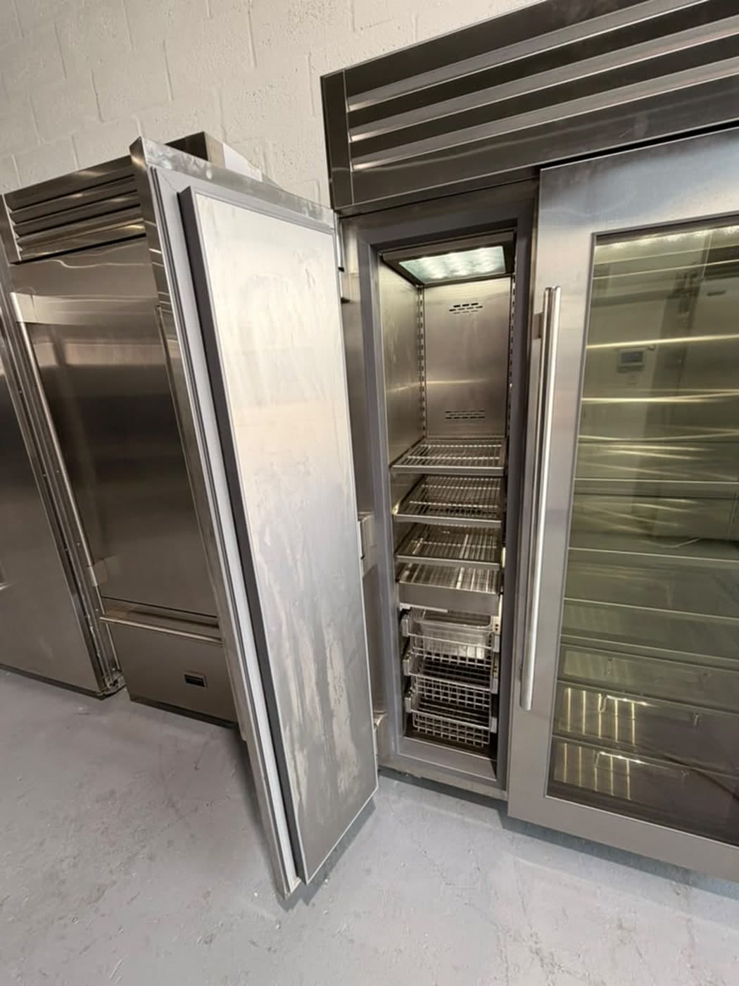 Actual true residential 48-inch refrigerator with glass door photographed in Oakland Park — actual unit · solid door open
