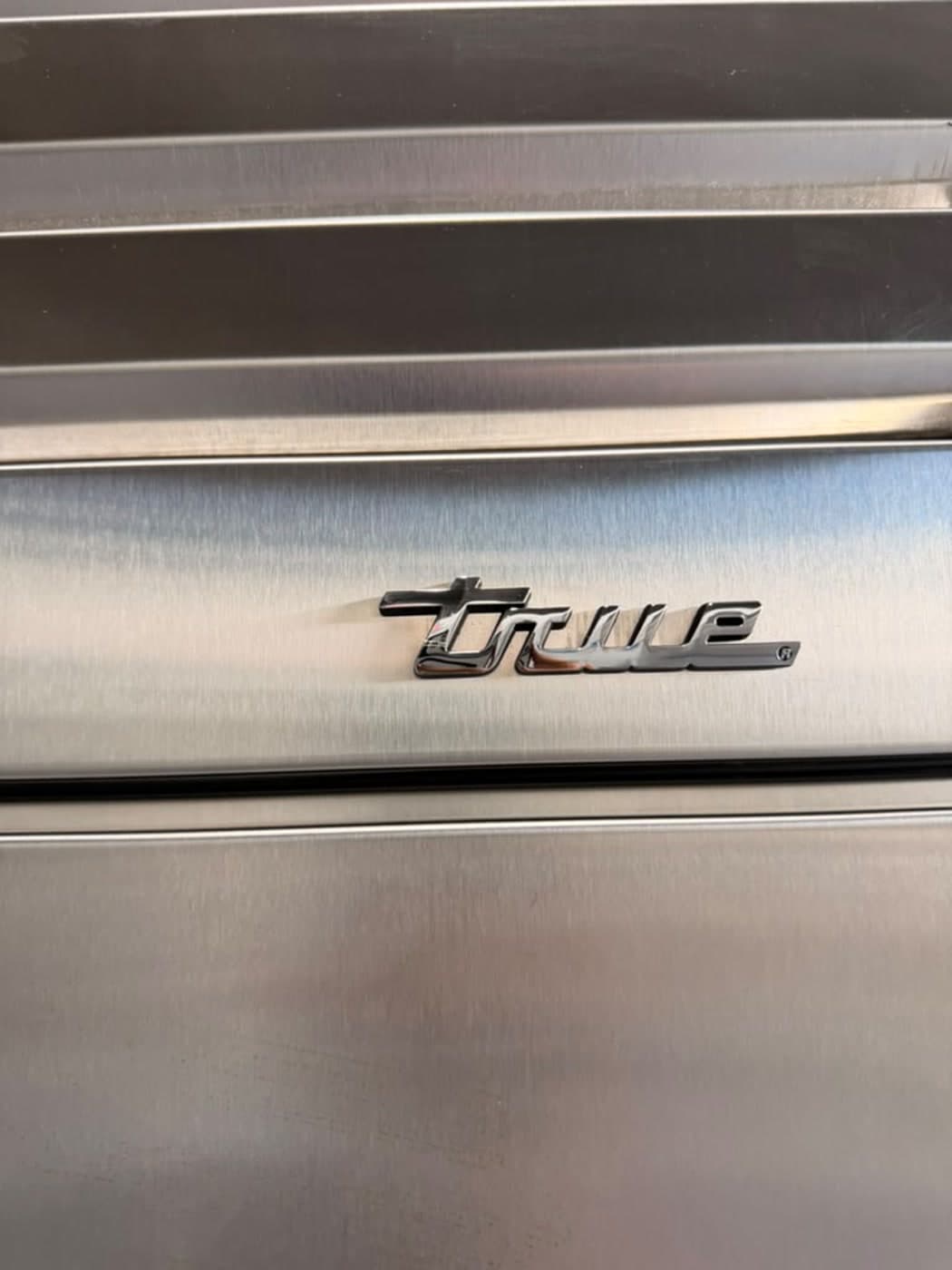 Actual true residential 48-inch refrigerator with glass door photographed in Oakland Park — actual unit · true badge detail