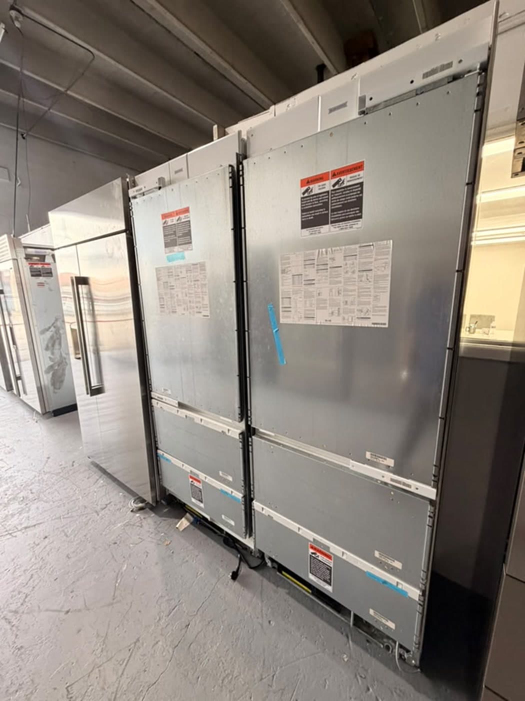 Actual sub-zero panel-ready bottom-freezer pair photographed in Oakland Park — actual units · alternate closed angle