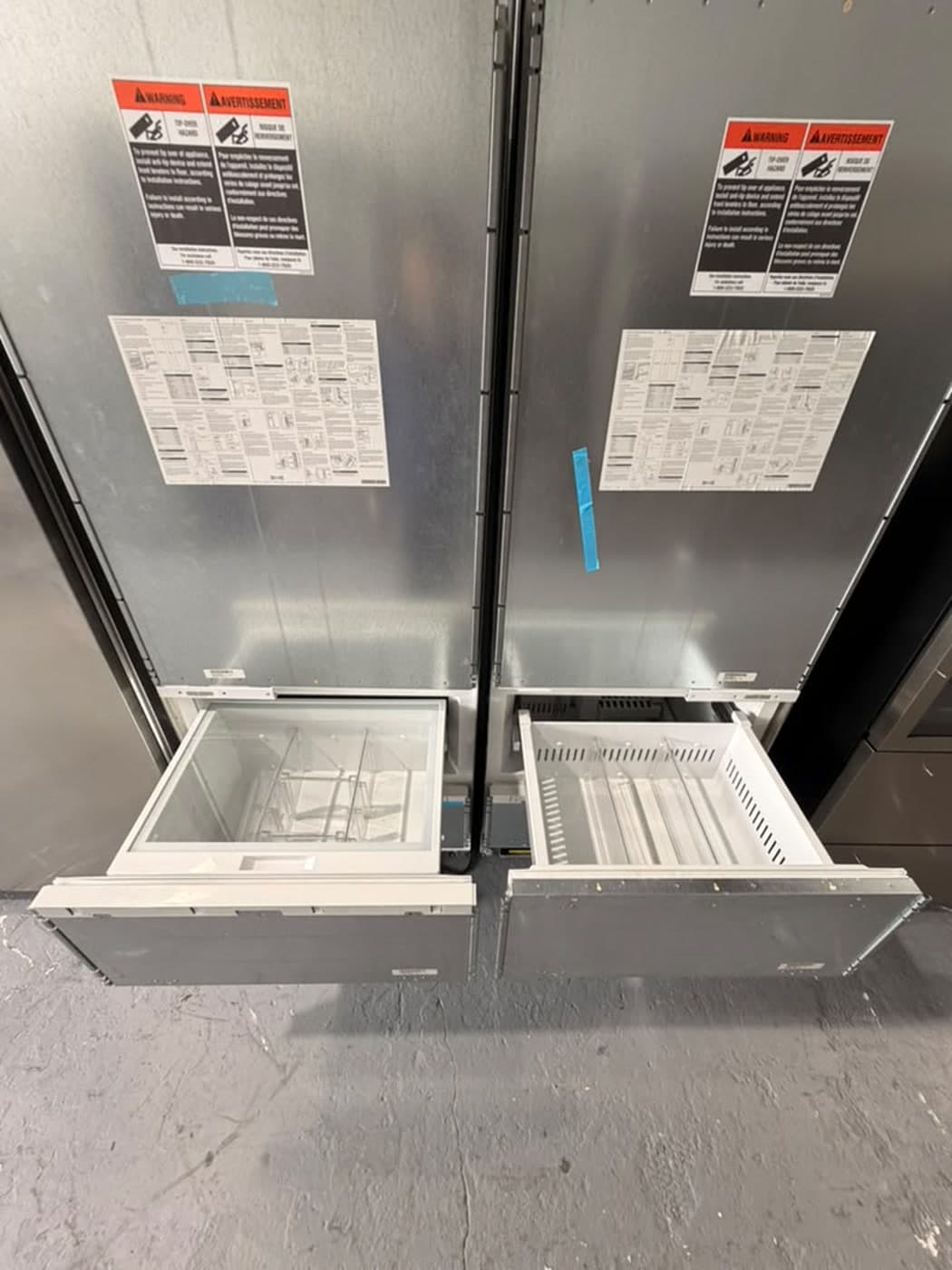 Actual sub-zero panel-ready bottom-freezer pair photographed in Oakland Park — actual units · freezer drawers open