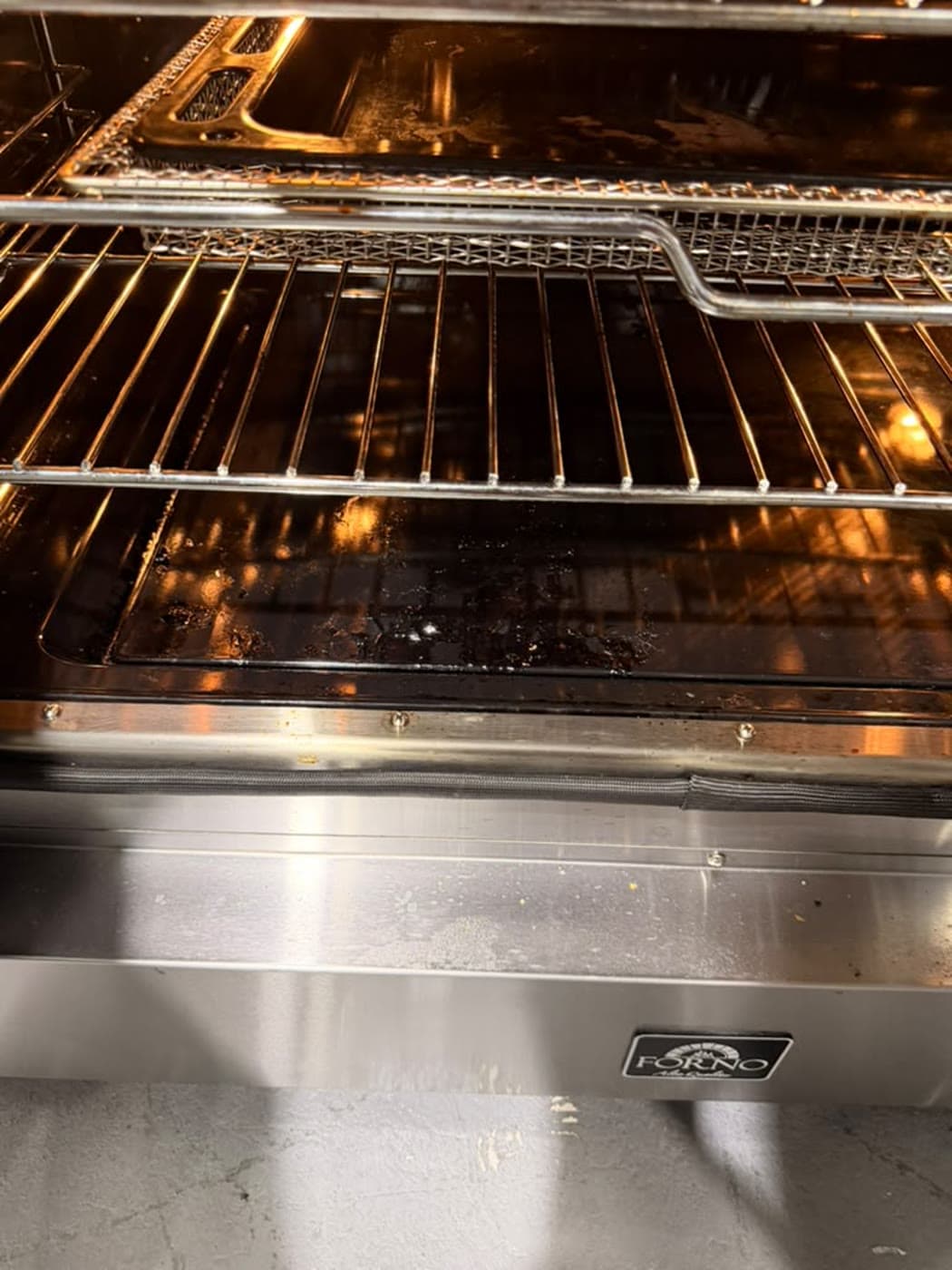 Actual forno 36-inch electric french-door range photographed in Oakland Park — actual unit · oven interior and racks